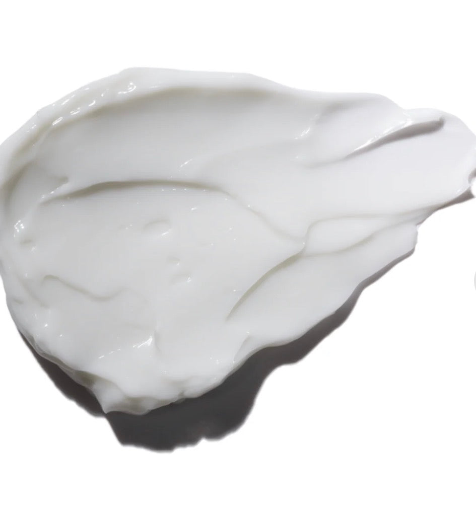 White cream in a small container on a white background