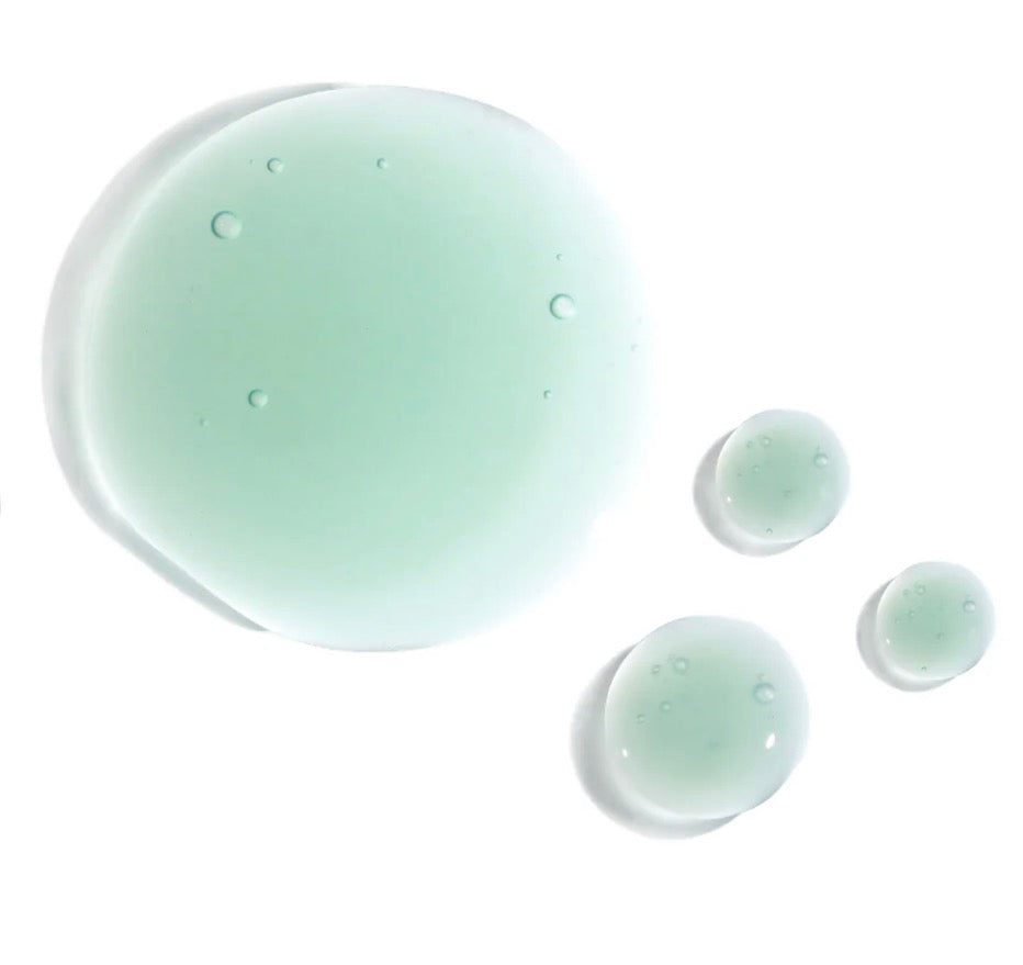 Green liquid droplets on a white background