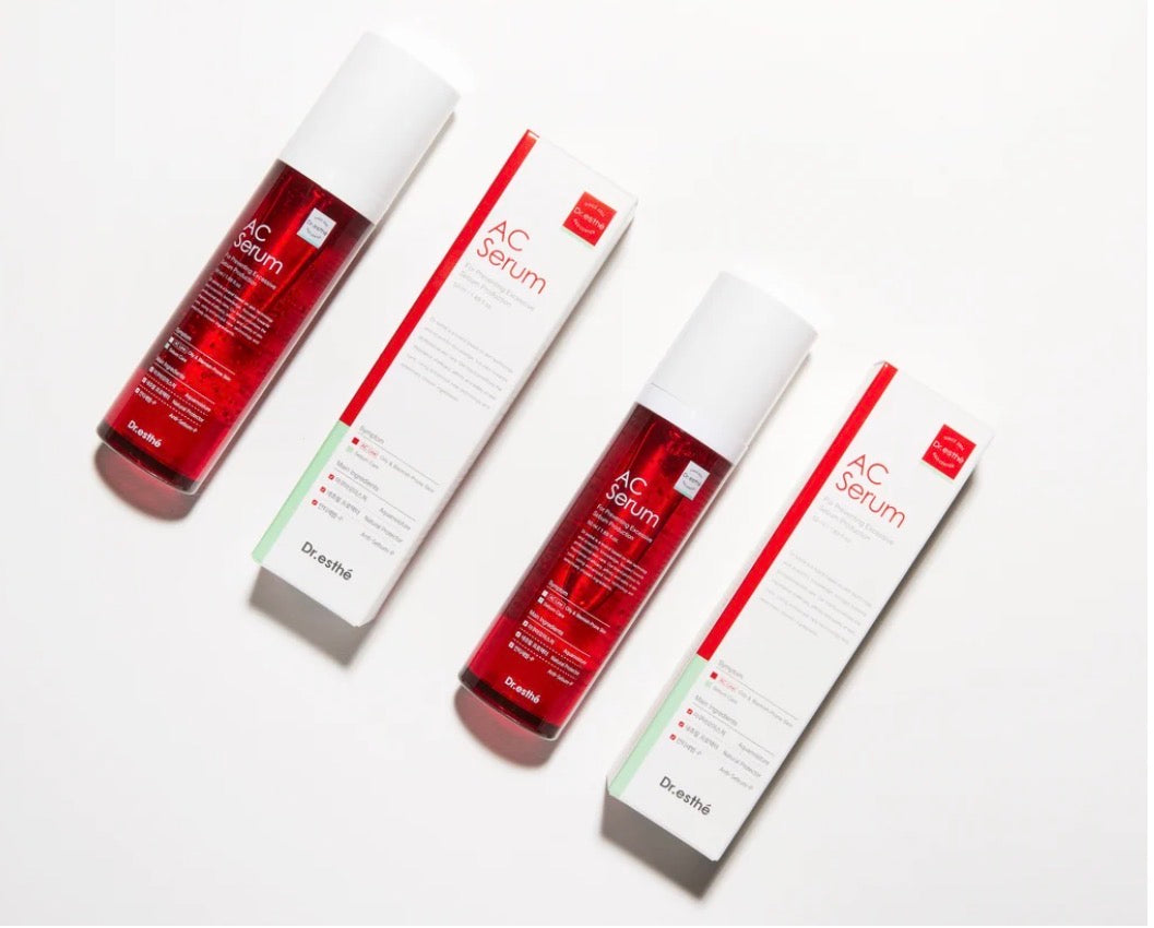 Three Dr. Artïás AC Serum bottles with white caps are arranged diagonally alongside their white packaging boxes on a clean white background.